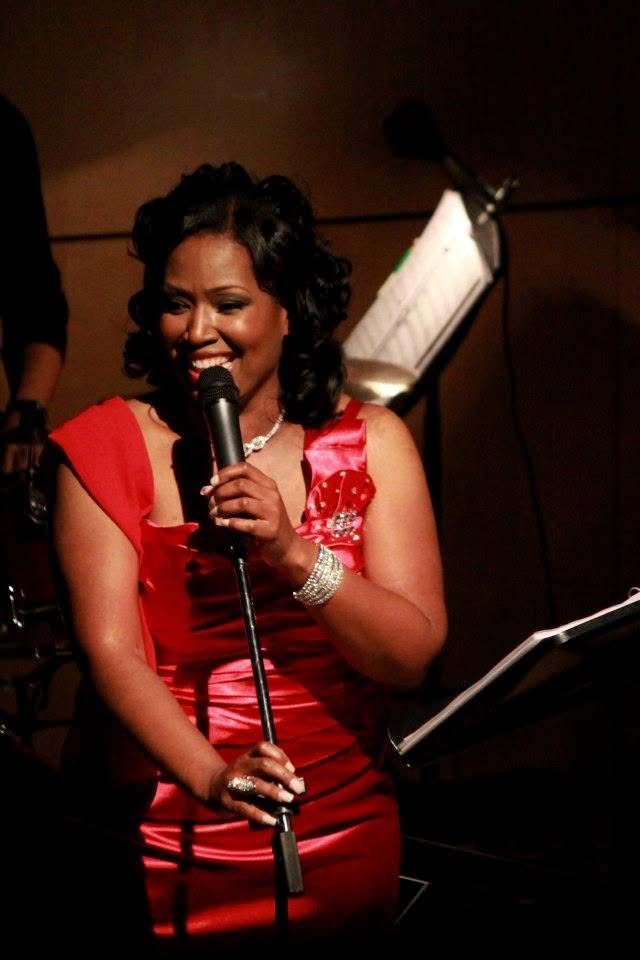 Smiling at the mic in red
